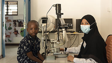 A female doctor is examining a 9-year-old boy Kassim at Kwale Eye Hospital in Kenya. 