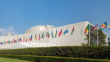 Flags fly in front of the United Nations general assembly building